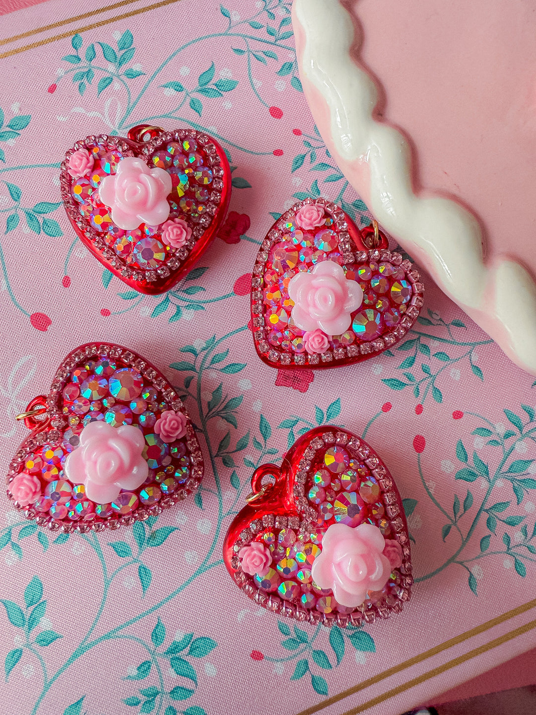 Puffy Heart Pendants covered in rhinestones with a big flower bead in the middle